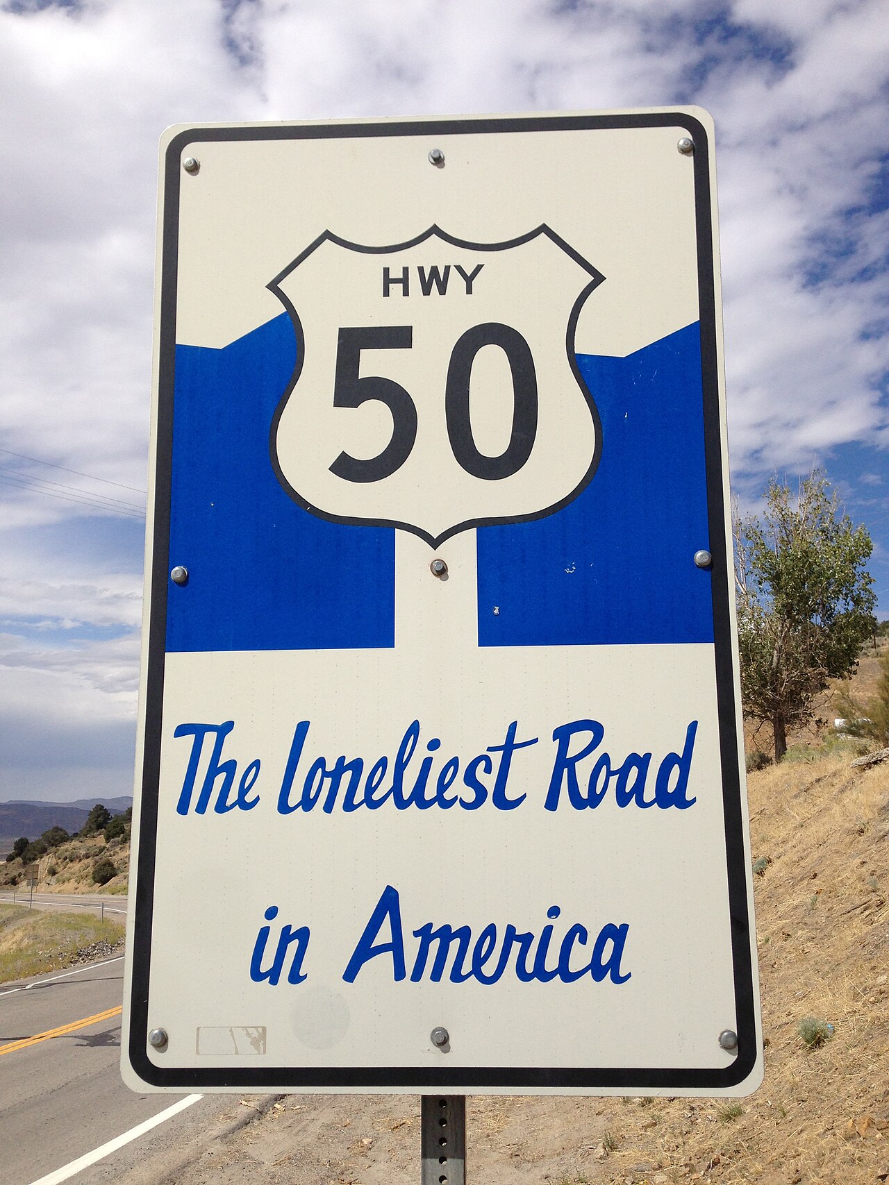 2014-09-08 13 29 20 "HWY 50 - The Loneliest Road in America" sign along westbound U.S. Route 50 about 23.8 miles east of the Churchill County line in Austin, Nevada.JPG
